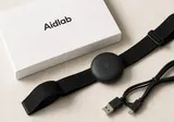 Aidlab box with sensor, strap, and Micro-USB cable