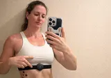 Woman wearing Aidlab chest sensor during training